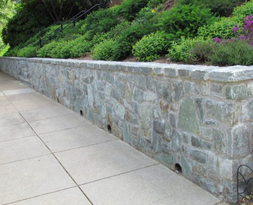 Retaining wall with weep holes for drainage