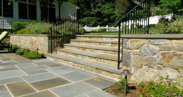 Stone steps coordinate with the stone retaining wall