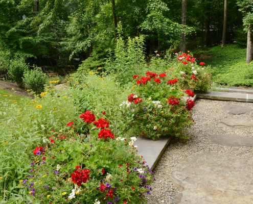 Flowers soften and provide color at front entrance